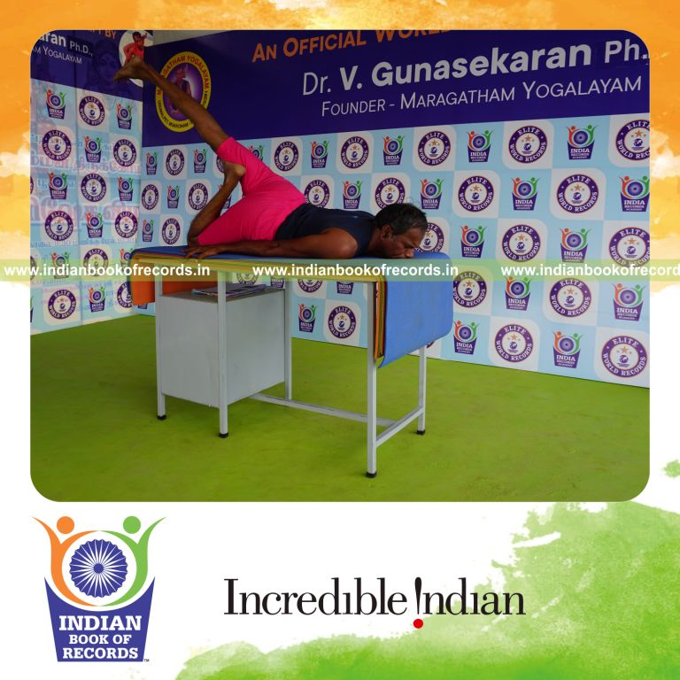 individual holding daksina janu salabhasana yoga pose on a table for record in Indian Book of Records