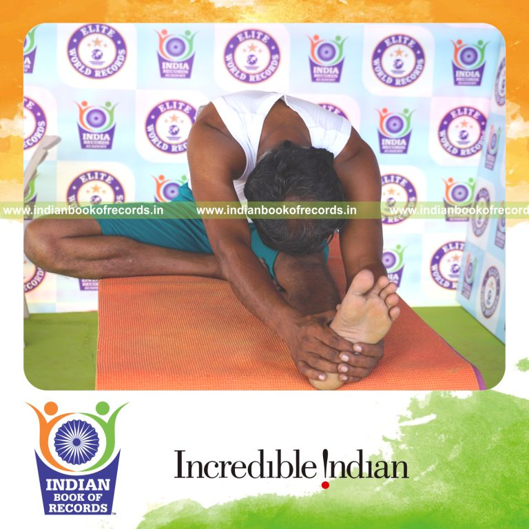 an individual holding daksina janu sirsasana yoga pose blindfolded on a table continuously for the longest duration with balance and control for a record in Indian Book of Records