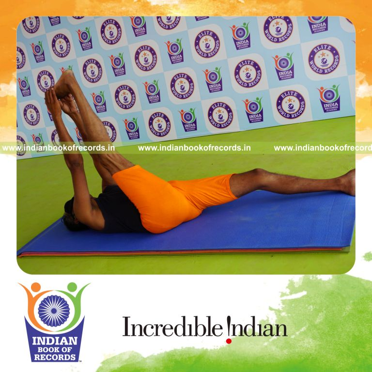 individual holding daksina julasana yoga pose blindfolded for record in Indian Book of Records