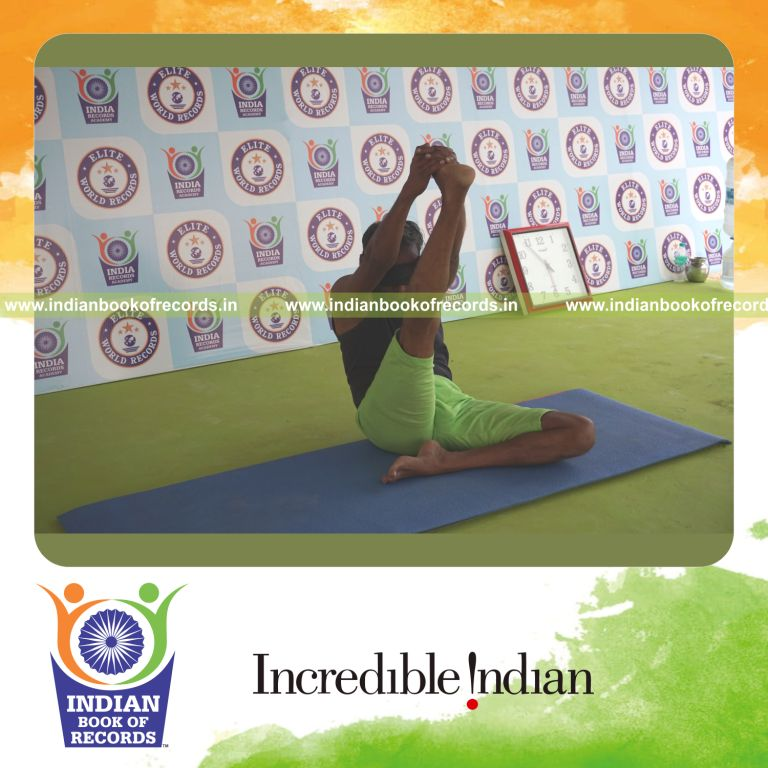 an individual holding daksina krounchasana yoga pose blindfolded for the longest duration with flexibility and stability for a record in Indian Book of Records