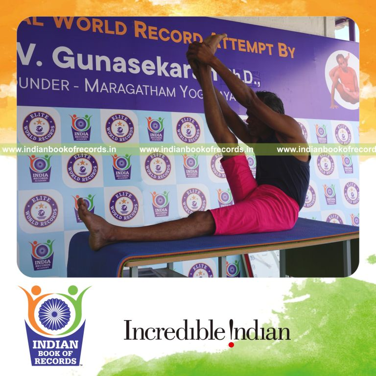 an individual holding daksina krounchasana yoga pose on a table for the longest duration with stability and flexibility for a record in Indian Book of Records