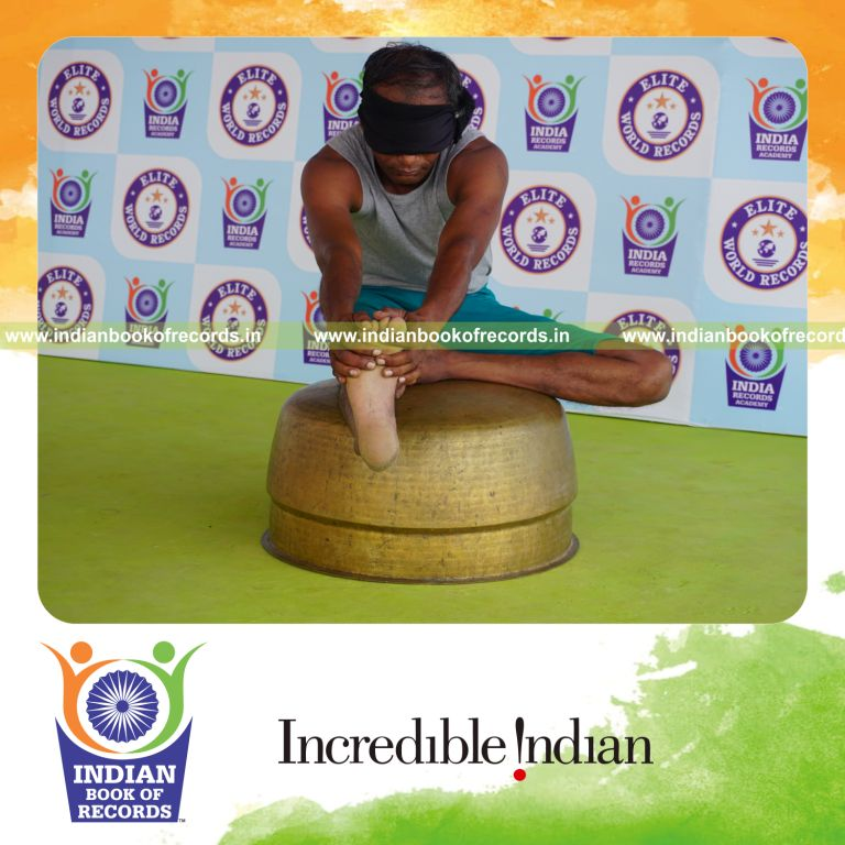 individual holding daksina mahamudra yoga pose blindfolded on a vessel for record in Indian Book of Records