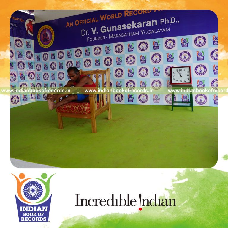 individual holding daksina mahamudra yoga pose on a chair for record in Indian Book of Records
