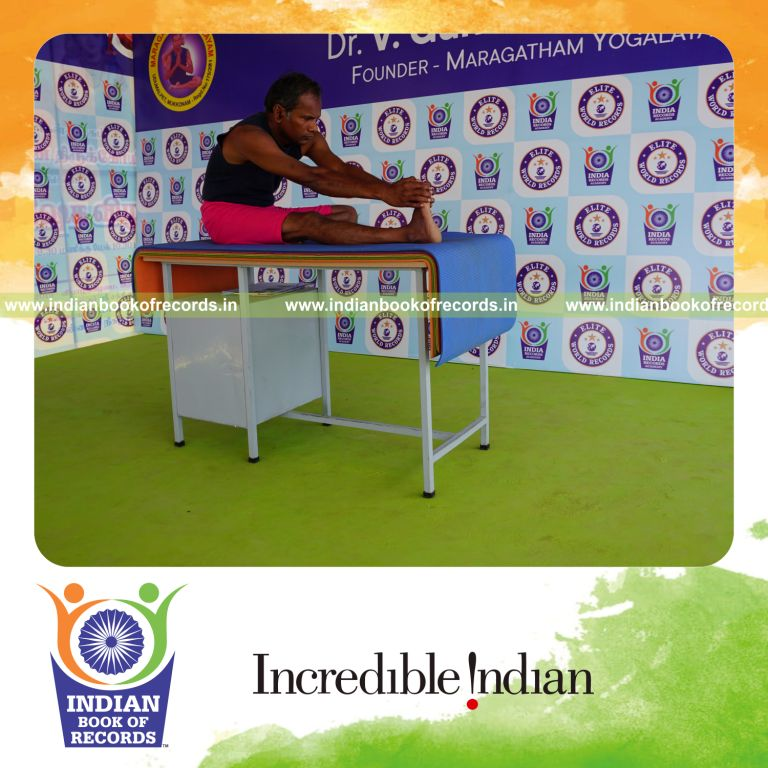 individual holding daksina mahamudra yoga pose on a table for record in Indian Book of Records