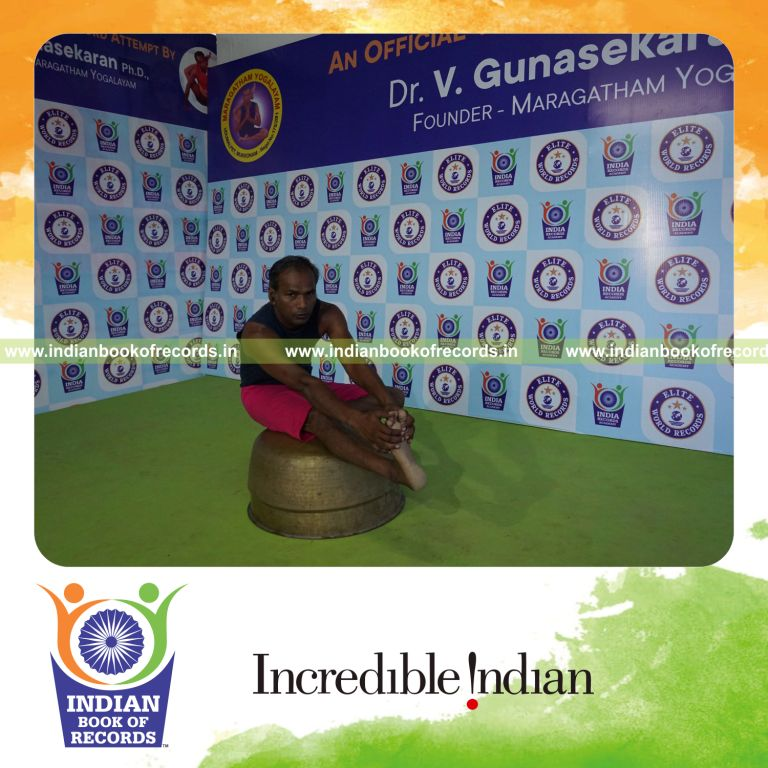 individual holding daksina mahamudra yoga pose on a vessel for record in Indian Book of Records