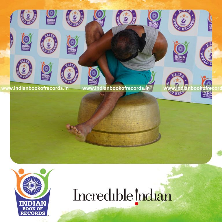 individual holding daksina marichyasana yoga pose blindfolded on a vessel for record in Indian Book of Records