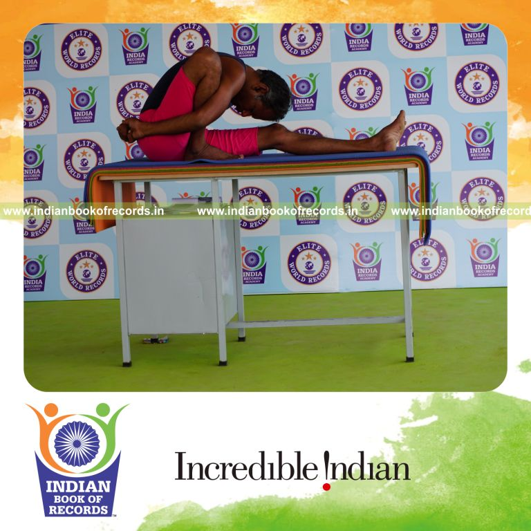 individual holding daksina marichyasana yoga pose on a table for record in Indian Book of Records