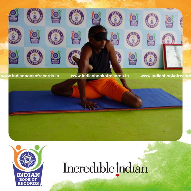 individual holding daksina mrigasana yoga pose blindfolded for record in Indian Book of Records