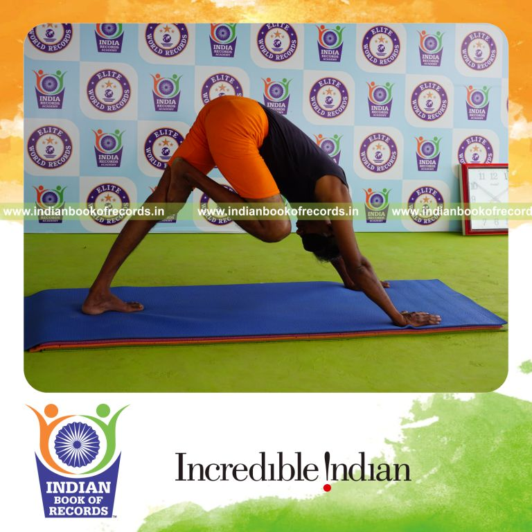 individual holding daksina nasika prusta janu parsavasana yoga pose blindfolded for record in Indian Book of Records