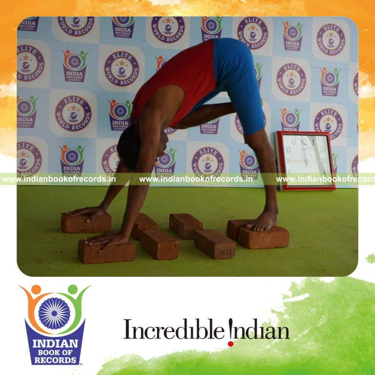 individual holding daksina nasika prusta janu parsavasana yoga pose on bricks for record in Indian Book of Records