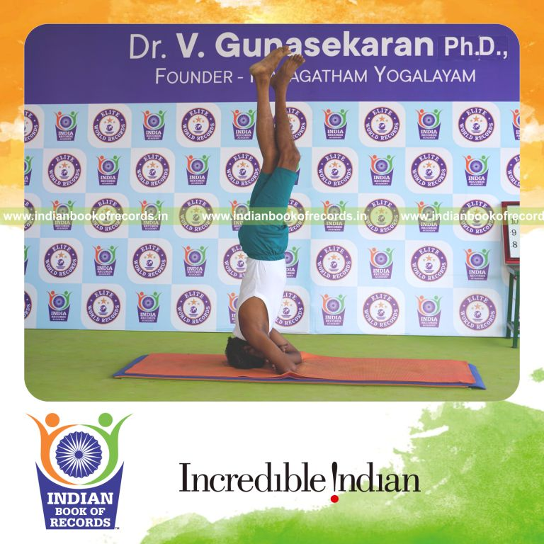 an individual holding daksina parivrtaikapata baddha hastha sirsasana yoga pose blindfolded continuously for the longest duration with control and balance for a record in Indian Book of Records