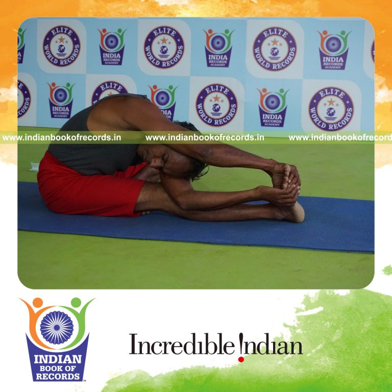 individual holding daksina parivrtana janu sirsasana yoga pose for record in Indian Book of Records