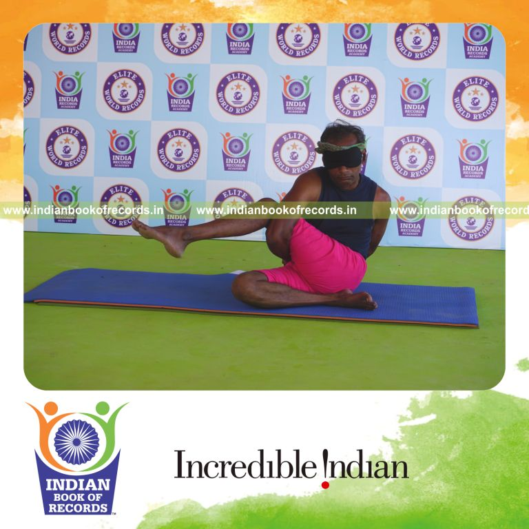 an individual holding daksina parivrtta ardha matsyendrasana yoga pose blindfolded for the longest duration with flexibility and control for a record in Indian Book of Records
