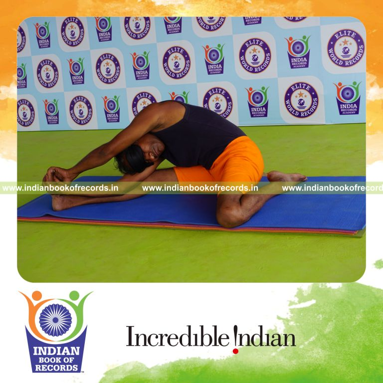 individual holding daksina parivrtta gomukha janu sirsasana yoga pose blindfolded for record in Indian Book of Records