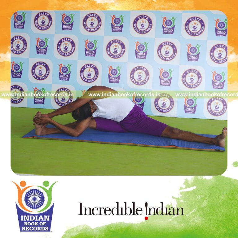 individual holding daksina parivrtta upavistha konasana yoga pose blindfolded for record in Indian Book of Records
