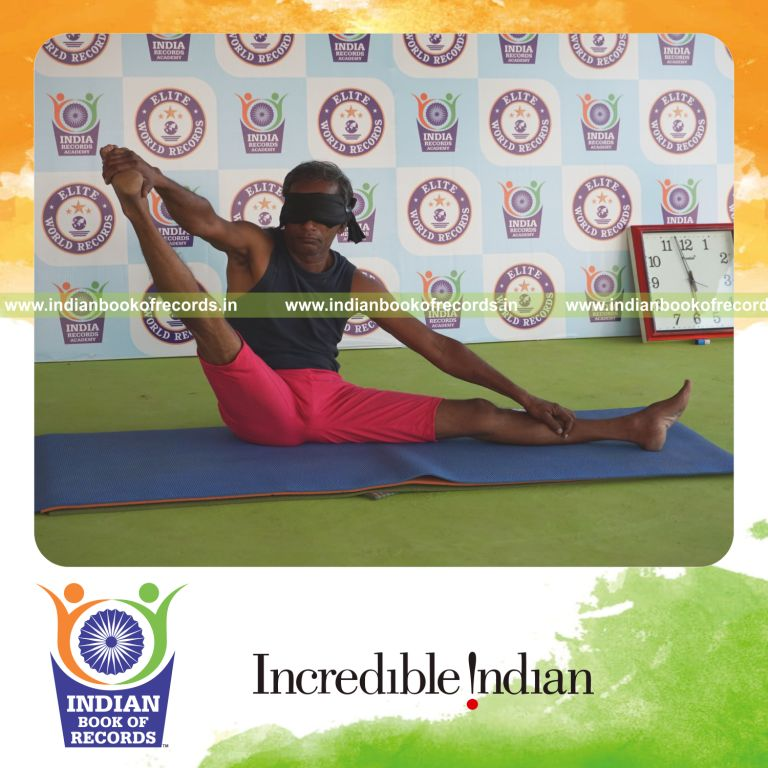 individual holding daksina parsva akarna dhanurasana yoga pose blindfolded for record in Indian Book of Records