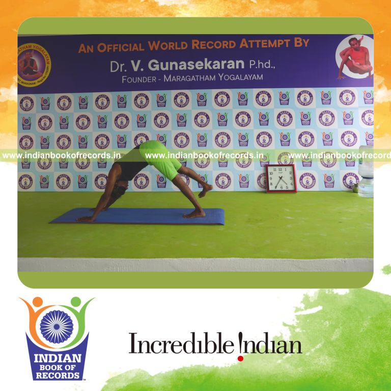 an individual holding daksina parsva ekapada adho mukha svanasana yoga pose blindfolded for the longest duration with balance and endurance for a record in Indian Book of Records