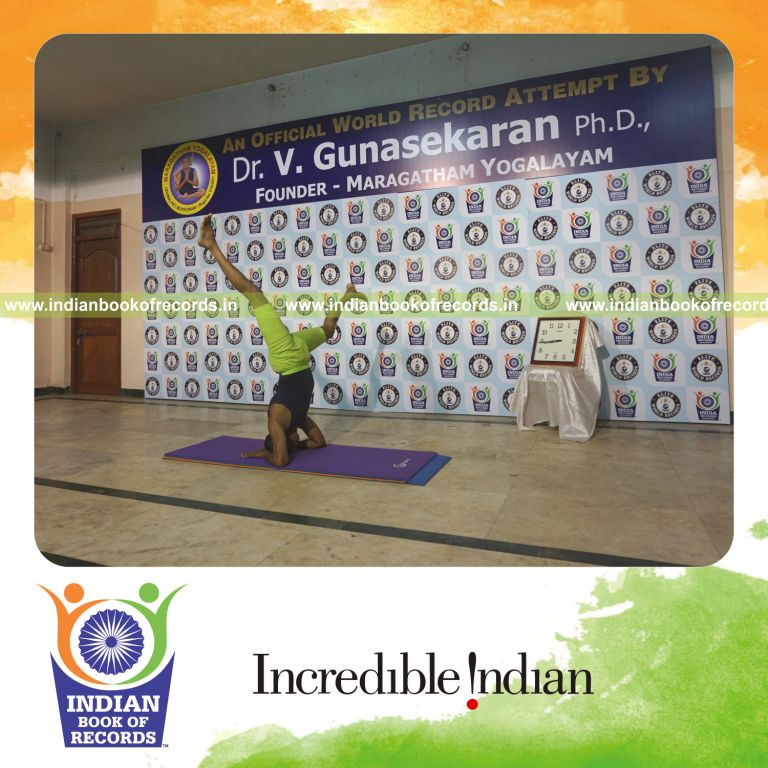 individual holding daksina parsva ekapada salamba sirsasana yoga pose blindfolded for record in Indian Book of Records