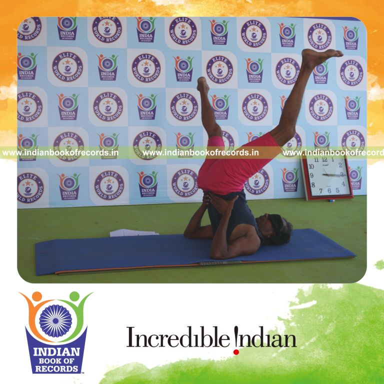 an individual holding daksina parsva ekapada sarvangasana yoga pose blindfolded for the longest duration with control and balance for a record in Indian Book of Records
