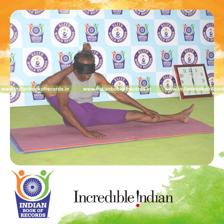individual holding daksina parsva ekapada sirsasana yoga pose blindfolded for record in Indian Book of Records