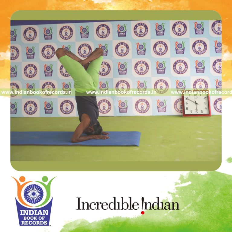 an individual holding daksina parsva padma salamba sirsasana yoga pose blindfolded for the longest duration with balance and control for a record in Indian Book of Records