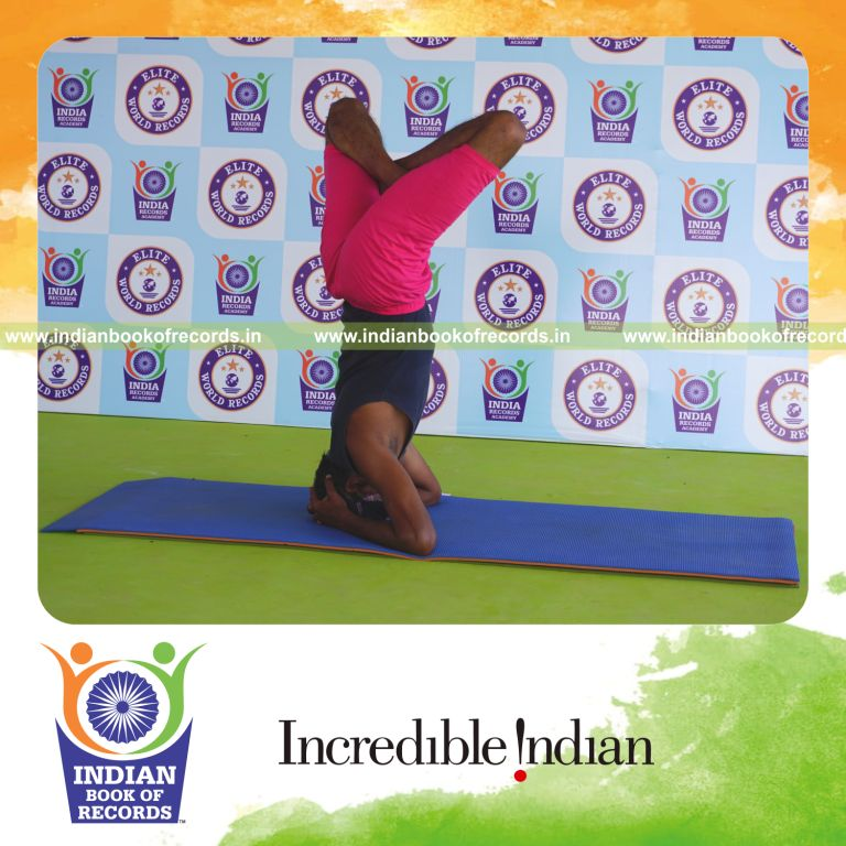 an individual holding daksina parsva padma sirsasana yoga pose blindfolded for the longest duration with balance and control for a record in Indian Book of Records