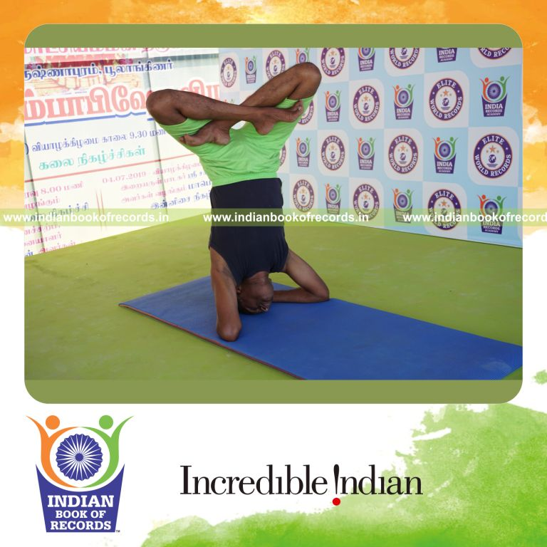 an individual holding daksina parsva padma sirsasana yoga pose continuously for the longest duration with stability and focus for a record in Indian Book of Records