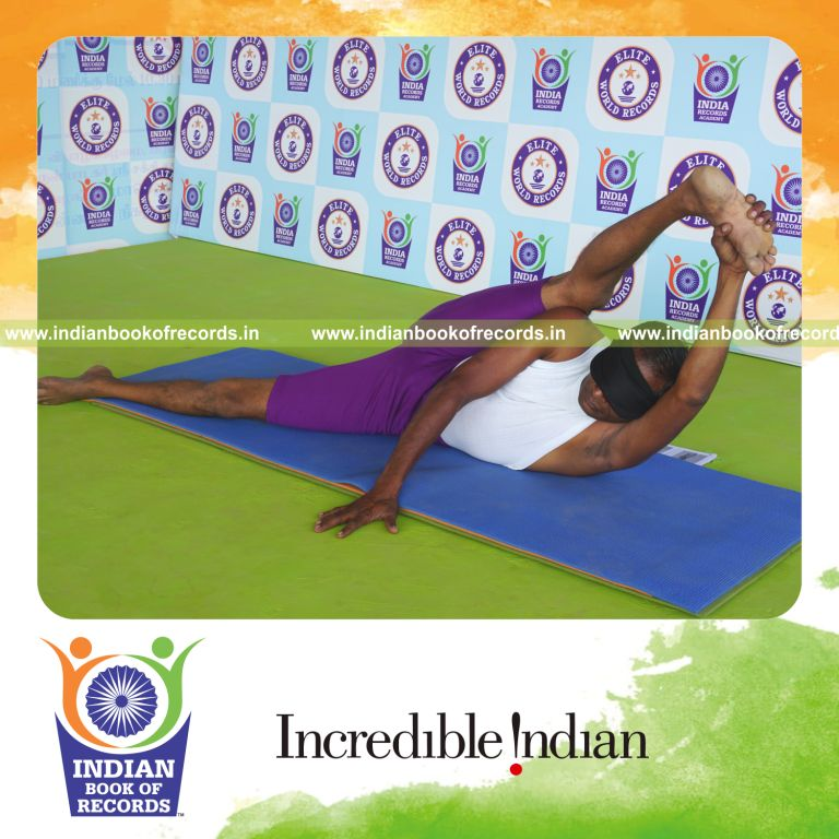 individual holding daksina purna anandasana yoga pose blindfolded for record in Indian Book of Records