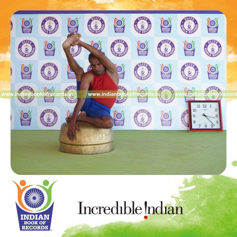 individual holding daksina purna krounchasana yoga pose on a vessel for record in Indian Book of Records