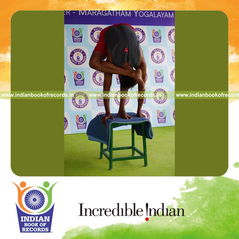 individual holding daksina ruchikasana yoga pose blindfolded on a stool for record in Indian Book of Records