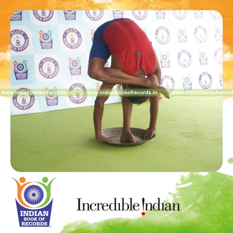 individual holding daksina ruchikasana yoga pose on a brass plate for record in Indian Book of Records