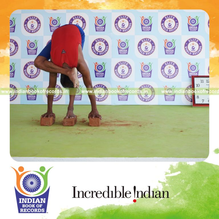 individual holding daksina ruchikasana yoga pose on bricks for record in Indian Book of Records