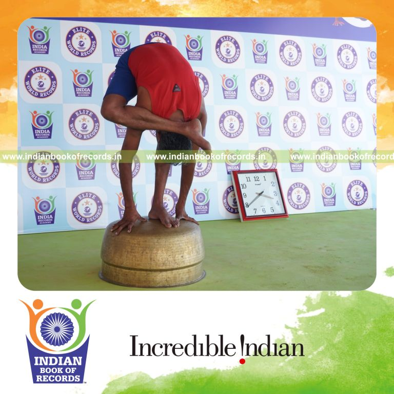 individual holding daksina ruchikasana yoga pose on a vessel for record in Indian Book of Records