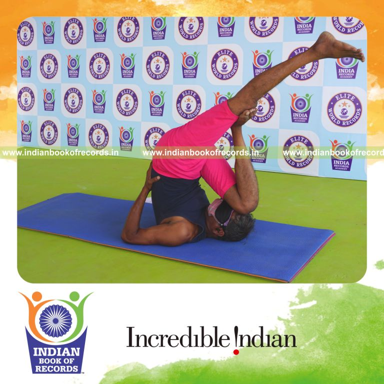 an individual holding daksina utthita kadi ekapada chakrasana yoga pose blindfolded for the longest duration with flexibility and control for a record in Indian Book of Records