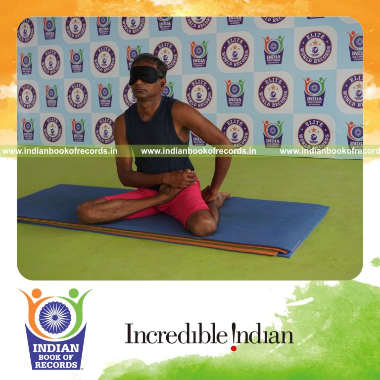 individual holding daksina vamadevasana yoga pose blindfolded for record in Indian Book of Records