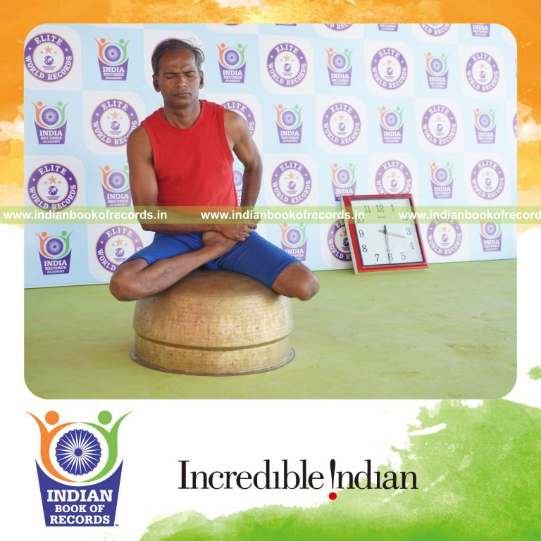 individual holding daksina vamadevasana yoga pose on a vessel for record in Indian Book of Records