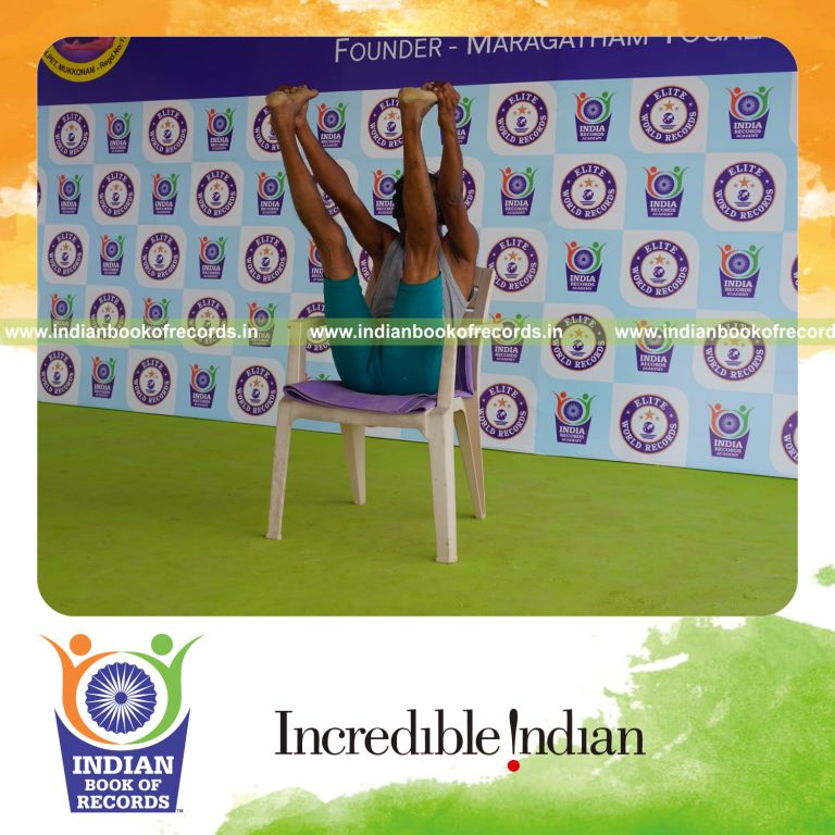 individual holding enkonasana yoga pose blindfolded on a chair for record in Indian Book of Records