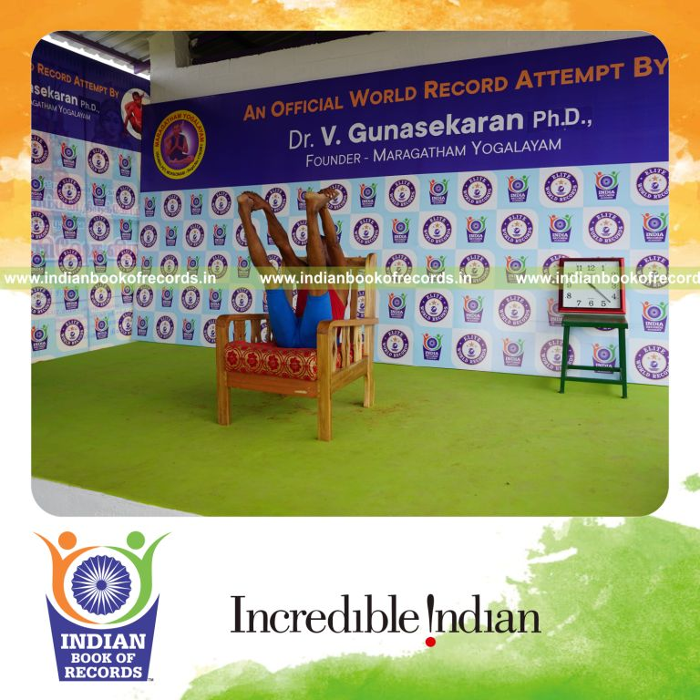 individual holding enkonasana yoga pose on a chair for record in Indian Book of Records