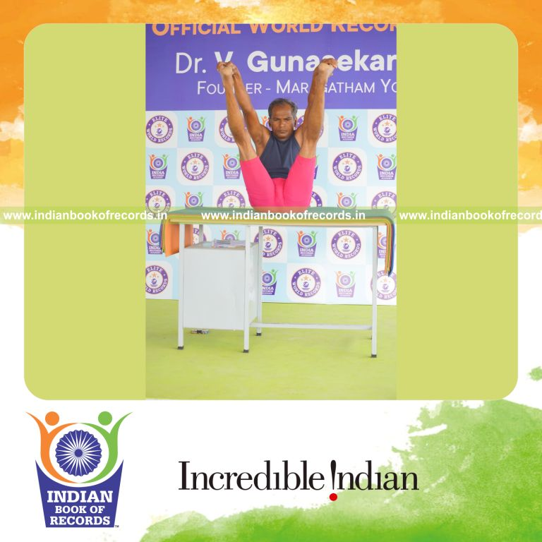 individual holding enkonasana yoga pose on a table for record in Indian Book of Records