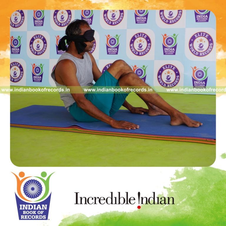 individual holding garuda navasana yoga pose blindfolded for record in Indian Book of Records