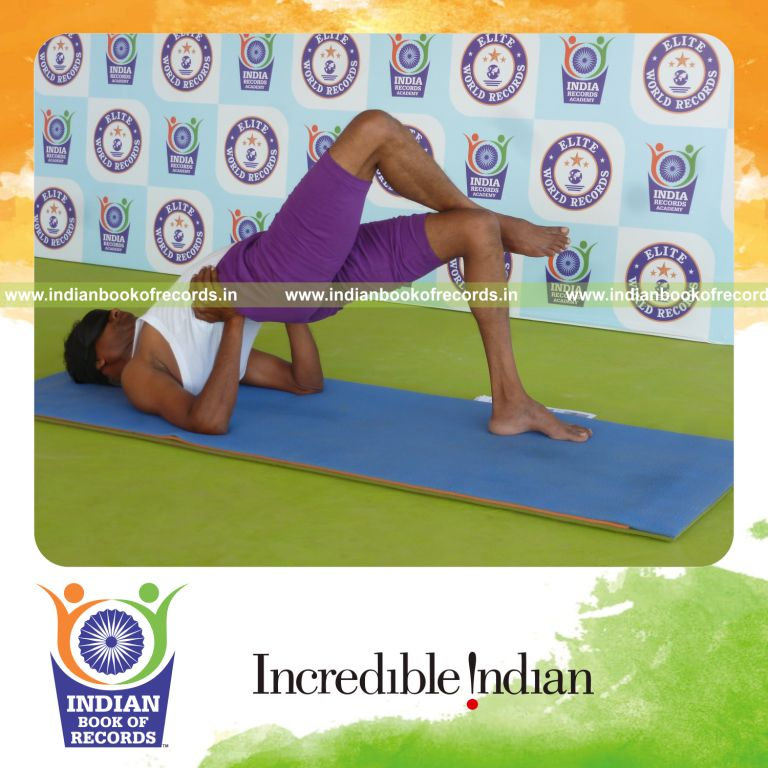 individual holding garuda setu bandha sarvangasana yoga pose blindfolded for record in Indian Book of Records