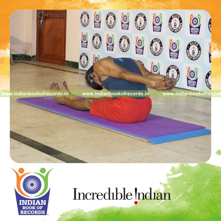 individual holding gopura paschimottanasana yoga pose blindfolded for record in Indian Book of Records