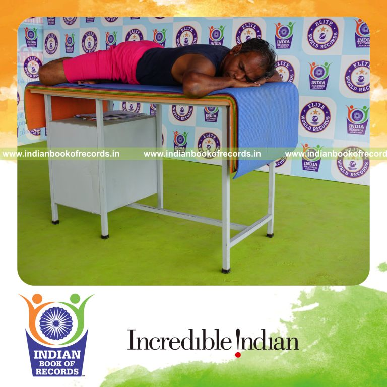 individual holding guptasana yoga pose on a table for record in Indian Book of Records