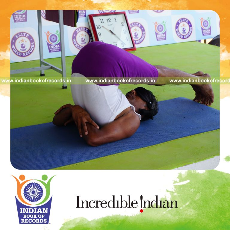 individual holding hastha halasana yoga pose blindfolded for record in Indian Book of Records