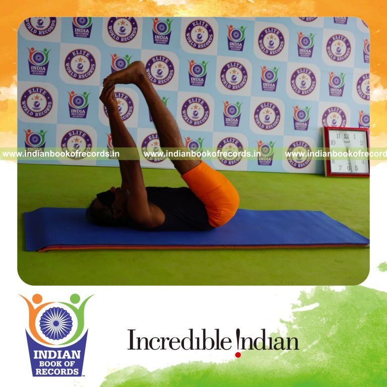 individual holding julasana yoga pose blindfolded for record in Indian Book of Records