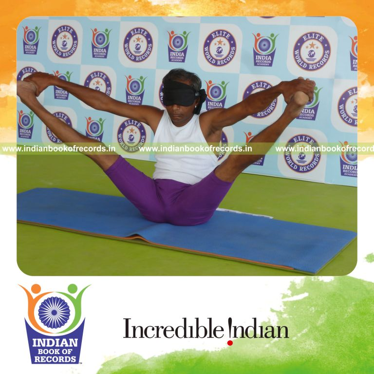 individual holding kakasana yoga pose blindfolded for record in Indian Book of Records