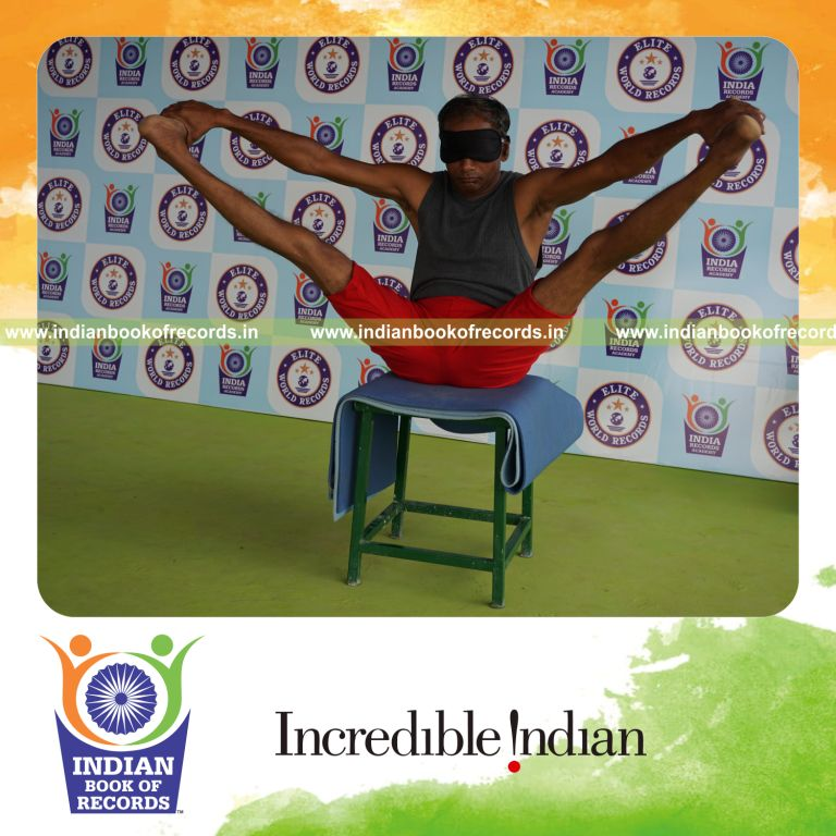 individual holding kakasana yoga pose blindfolded on a stool for record in Indian Book of Records
