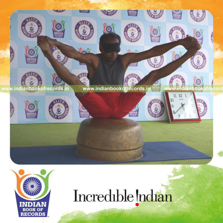 individual holding kakasana yoga pose blindfolded on a vessel for record in Indian Book of Records