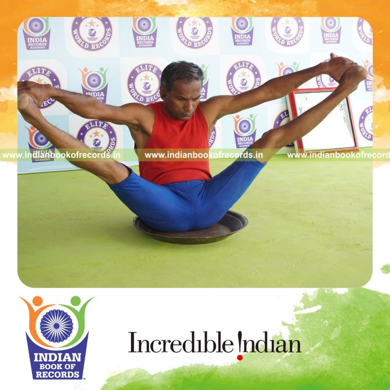 individual holding kakasana yoga pose on a brass plate for record in Indian Book of Records
