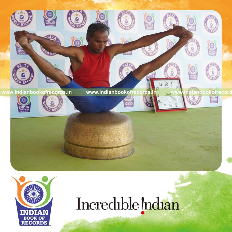 individual holding kakasana yoga pose on a vessel for record in Indian Book of Records